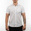A short sleeve shirt in white, featuring a front pocket and a logo on the chest area.