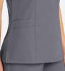 A women's mock wrap top in grey with a fitted design and visible pockets. It features a logo on the fabric.