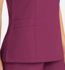 A purple women's mock wrap top with contrast trim and side pockets, featuring a sleek design.