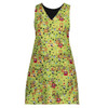 A green apron with a playful pattern featuring shapes and flowers, designed with a V-neck and sleeveless style.