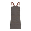 A grey apron with brown leather straps and multiple pockets, featuring a logo.