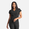 A woman in a black banded V-neck top smiles, with the top featuring short sleeves and a subtle logo.