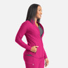 A full zip track jacket in vibrant pink, featuring a sleek design and pockets, worn by a smiling model.