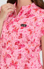A pink blouse featuring a butterfly and heart print, with a small logo on the chest area.