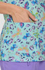 A top featuring a light turquoise background with colourful butterfly and animal print designs, including a pocket.