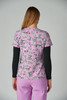 A floral patterned top in shades of pink with black details, worn with black long sleeves underneath.