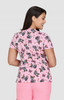 A short-sleeved top featuring a pink butterfly print, designed with a fitted silhouette and a branded logo.