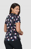 A printed top featuring a dark navy background with colourful patterns of cartoon characters and shapes.
