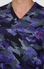 A scrub top featuring a purple and grey camouflage design with a v-neck and a chest pocket holding a pen.