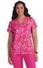 A pink floral scrub top featuring short sleeves, v-neckline, and a vibrant floral pattern.