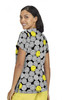 A short-sleeved women's top featuring a playful pattern of grey and yellow smiley faces, with a logo prominently displayed.
