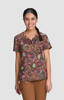 A printed brown top featuring vibrant patterns of pink, blue, and green. Includes a logo on the fabric.