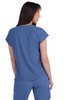 A woman wearing a blue top, viewed from the back, with short sleeves and a relaxed fit. The top includes a logo.