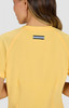A yellow top with a contrasting logo on the back, featuring short sleeves and a fitted design.