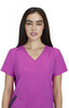 A pink Sari Top featuring a v-neck design and short sleeves, modelled by a woman with long dark hair.