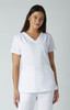 A white medical scrub top with a V-neck and two front pockets, displayed on a model against a light background.