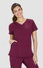 A burgundy Sari Top featuring a V-neck design and two front pockets, worn by a smiling model.