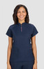 A navy blue women's top with a zip neck and two front pockets. The model is smiling and has wavy hair.