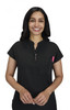 A black top with a short collar and a front pocket, featuring a pen. The model is smiling while standing.