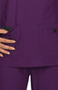 A purple scrub top featuring pocket details with a polka dot pattern. The fabric is smooth and lightweight.