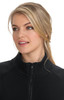 A black wellness jacket featuring a high collar and zip closure, worn by a model with long blonde hair.