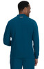 A man in a teal jacket is seen from the back, featuring a logo and a collar.