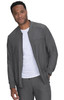 A man wears a grey jacket over a white shirt, featuring a zip pocket and a casual style. The jacket has a logo.
