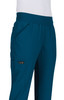 A pair of teal pants with pockets, featuring an elastic waistband and a logo on the side.