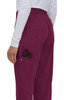 Burgundy jogger pants with a side pocket holding scissors, worn by a person facing sideways.