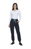 A woman in a white long-sleeve top and navy joggers with a mint green drawstring and pockets. The joggers have branding.