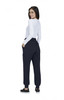 A woman wearing navy jogger pants with pockets, facing away, paired with a long-sleeve white top.