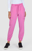 A pair of pink jogger pants featuring elastic cuffs and side pockets, styled with a white long-sleeve top.