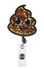 A glittery brown poop emoji badge with black outlines and a retractable clasp, featuring star accents and a logo.