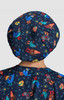 A bouffant scrub cap in navy featuring colourful animal patterns, including chickens and whimsical characters.