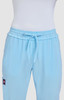 Light blue pants with a relaxed fit and drawstring waistband, featuring a logo on one side.