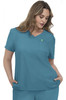 A woman wearing a teal scrubs top with a v-neck and a chest pocket. The top has a logo on it.