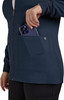 A women's navy jacket with a front zip and a pocket, where a smartphone is being placed. The jacket features a logo.