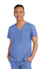 A man wearing a blue scrub top with a pocket, smiling at the camera. The outfit includes short sleeves and a v-neck.