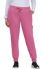 A pair of pink jogger pants with pockets and a drawstring waist, worn by a person standing with hands in pockets.