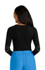 A black long-sleeve top with a speckled pattern and smiley face designs on the elbows, paired with blue pants.