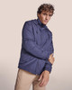 A water-repellent jacket in navy blue, featuring a hood and zip closure, modelled by a person.