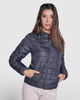 A waterproof women’s jacket in dark grey, featuring a zip front and side pockets. The model wears it stylishly.