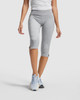 Mid-length grey leggings with a fitted design and side slits, paired with a white top and blue athletic shoes.
