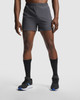 Sporty grey running shorts with an elastic waistband and branding, paired with black socks and footwear.