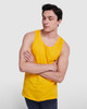 A young man in a bright yellow tank top with a casual pose and crossing his arms. The top has a logo.