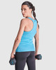 A woman in a blue tank top holds dumbbells, showcasing the back design while standing against a plain background.