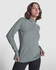 A half zip sweatshirt in a soft green colour, featuring a slim fit and a logo on the sleeve.