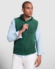 A green fleece vest with a high collar and front zip, modelled by a man in a light blue shirt and white pants.