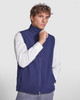 A navy softshell vest with a high collar, featuring a zip front and side pockets, worn by a model.