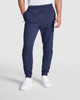 Navy track pants with a tapered fit and elastic waistband, featured with side pockets and a logo.